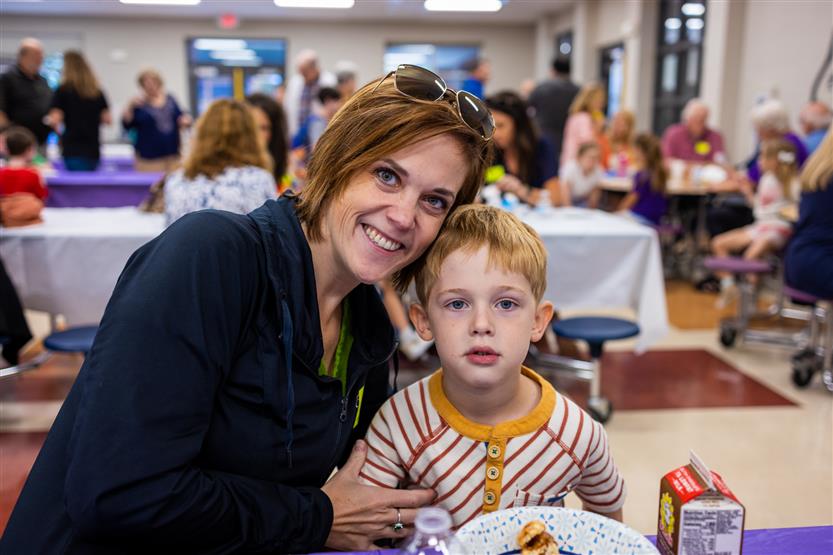 A family smiles at Winstead Elementary's Grandparents Breakfast